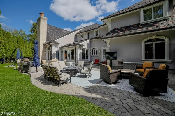 a view of a patio with couches table and chairs with plants