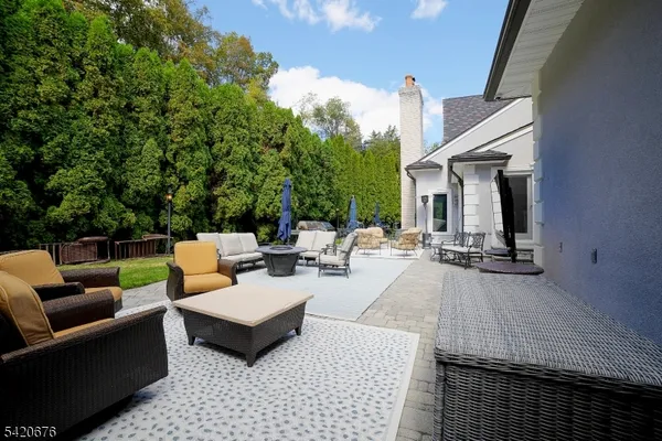 a view of a patio with couches and potted plants