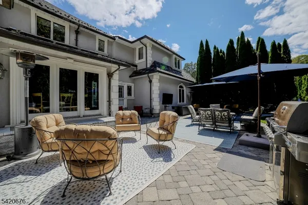 a view of a patio with table and chairs