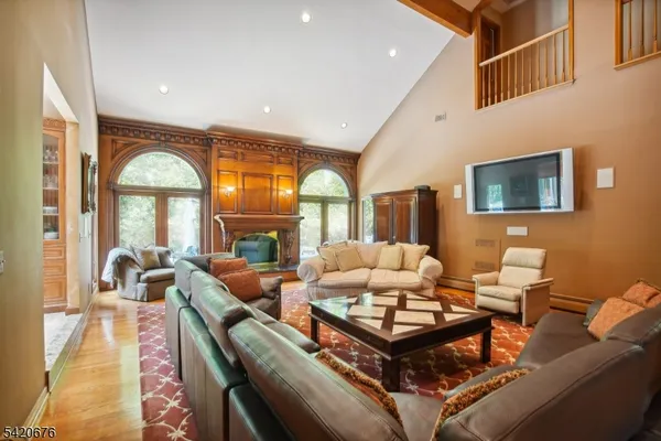 a living room with furniture fireplace and a large window