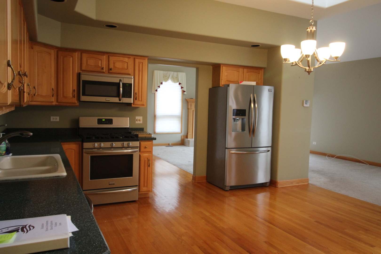 10 Moorings Drive Palos Heights, IL 60463 - Photo 15 of 19 a kitchen with granite countertop a refrigerator and a stove top oven