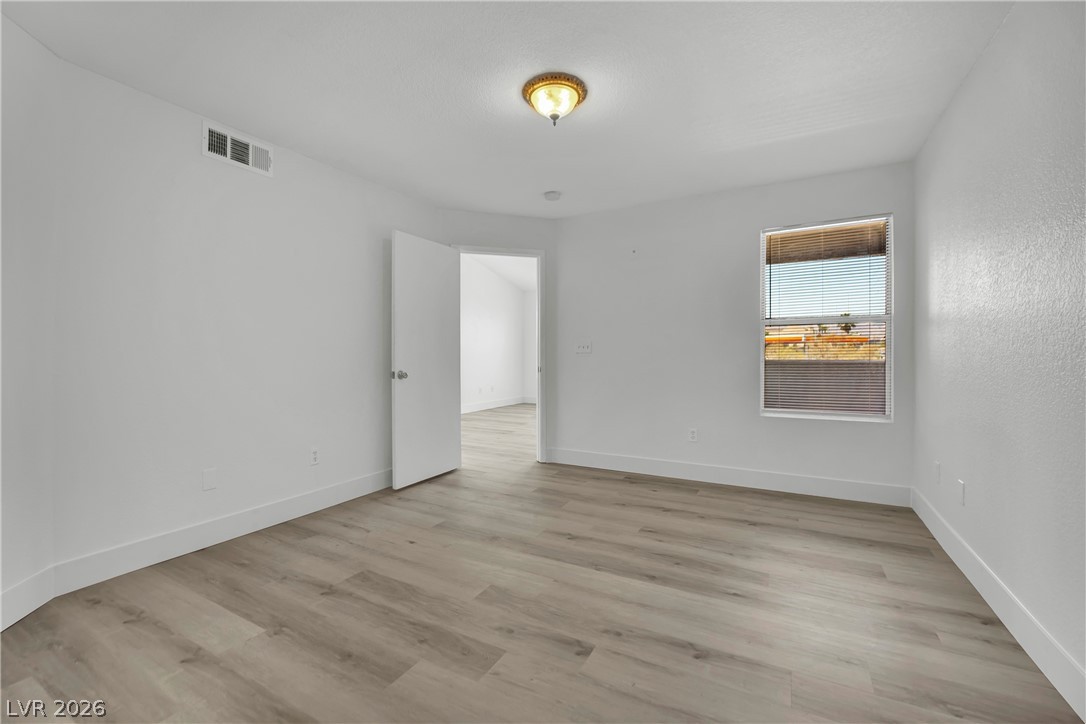 8101 West Flamingo Road, Unit 2030 Las Vegas, NV 89147 - Photo 14 of 27 A well-lit bedroom features durable laminate flooring, offering comfort and ease.