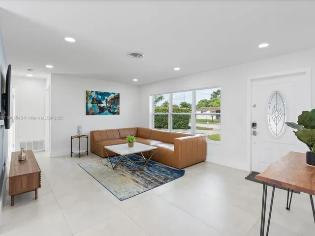 a kitchen with a table chairs and white cabinets