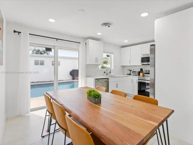 a kitchen with stainless steel appliances granite countertop a refrigerator sink and stove