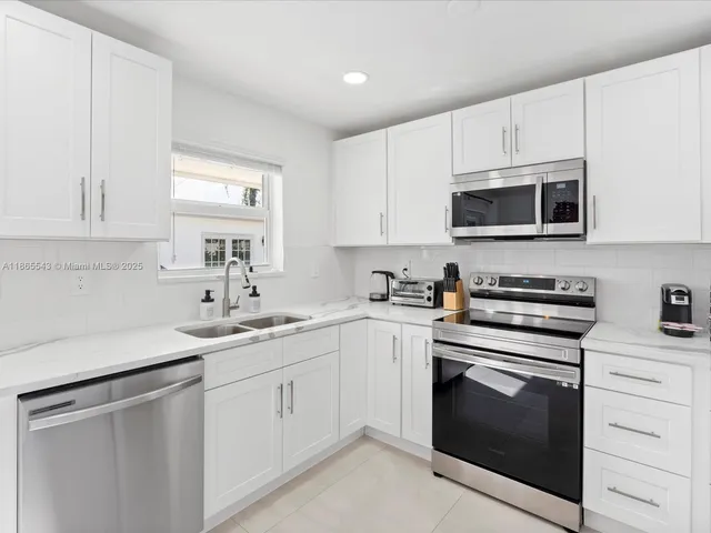 a bathroom with a toilet sink and a mirror