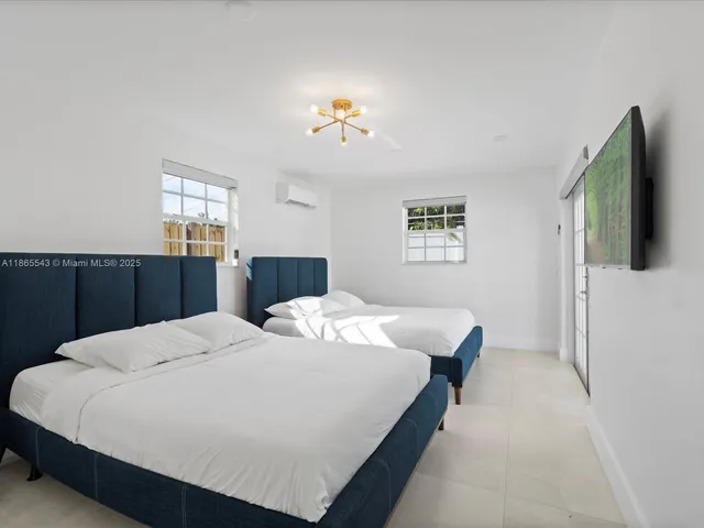 a bed sitting in a bedroom next to a window