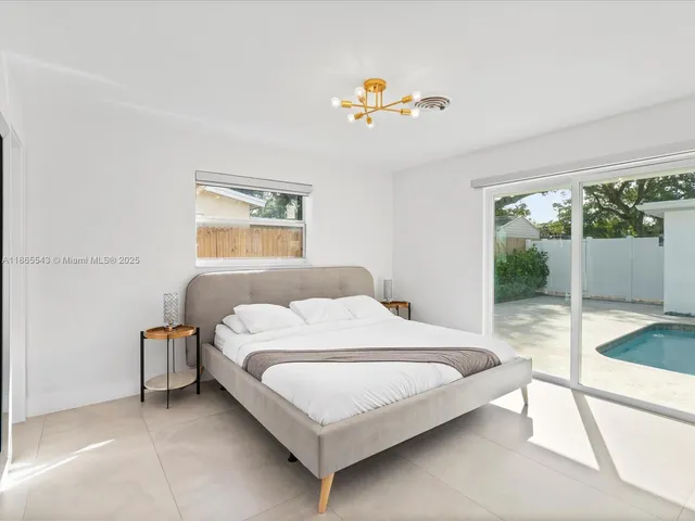a bedroom with two beds and a chandelier