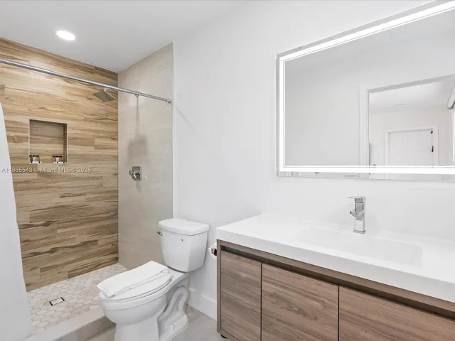 a bedroom with a bed and a large window with outer view