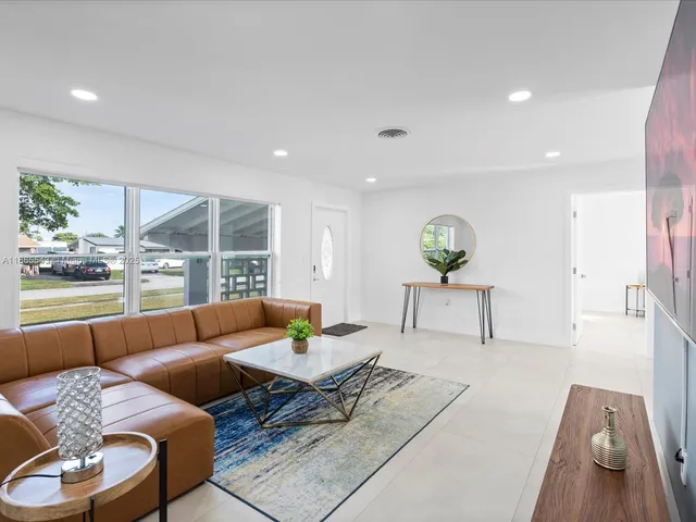 a living room with furniture and a rug