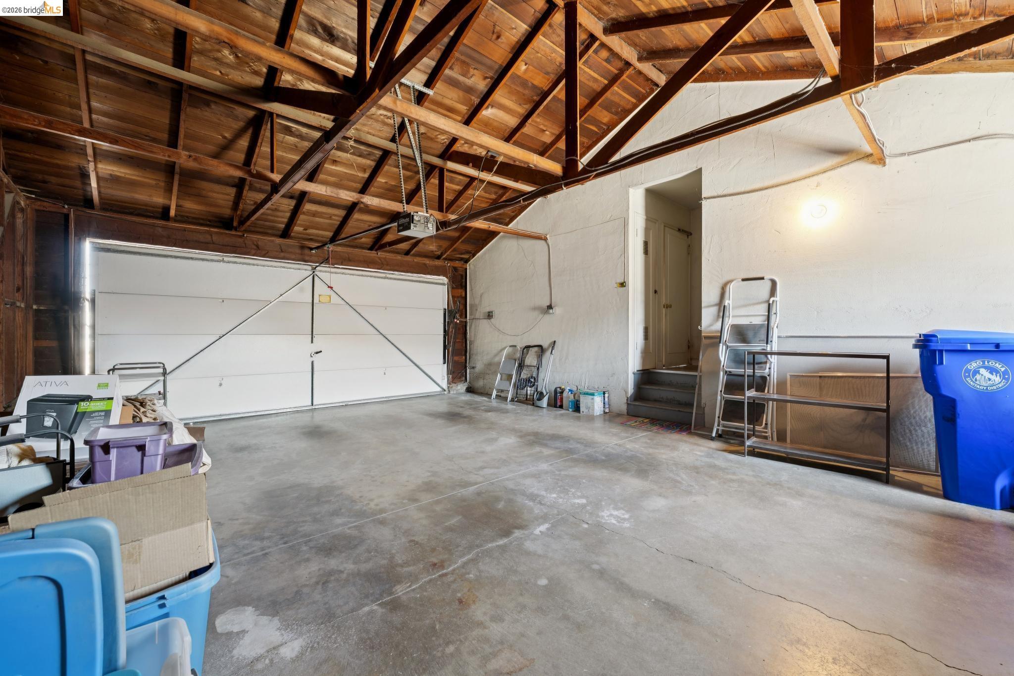 15162 Inverness Street San Leandro, CA 94579 - Photo 23 of 25 Spacious garage featuring exposed wood beam ceilings and a concrete floor