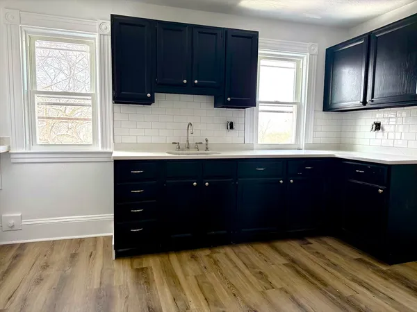 a kitchen with a sink and a window