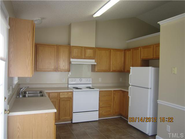 4445 Archibald Way Raleigh, NC 27616 - Photo 3 of 9 a kitchen with a stove and a refrigerator