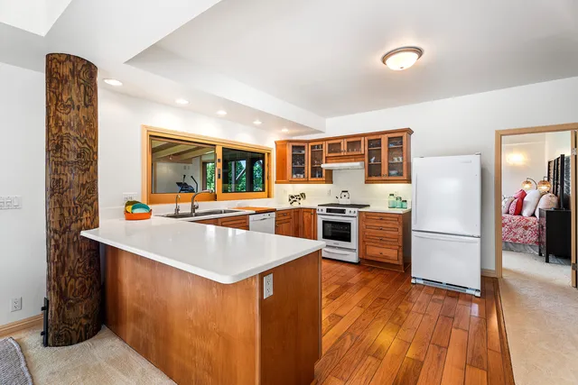 a kitchen with a refrigerator and a stove top oven