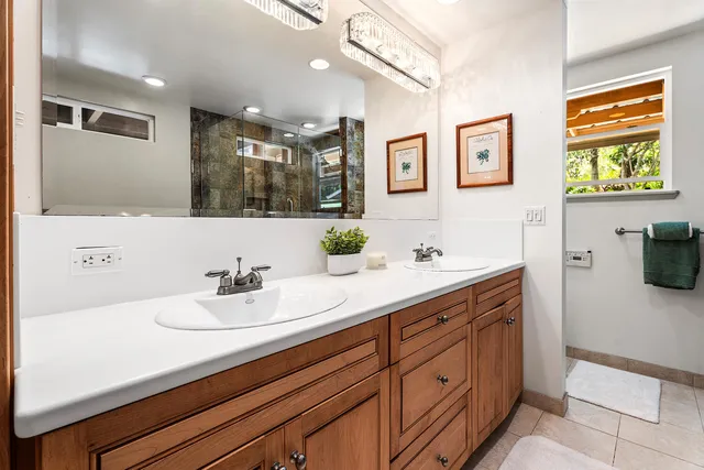 a bathroom with a sink double vanity and a mirror