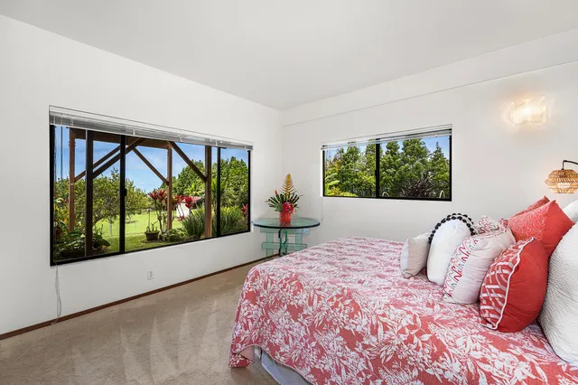 a bedroom with a large bed and a large window