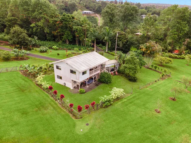 an aerial view of a house with a yard
