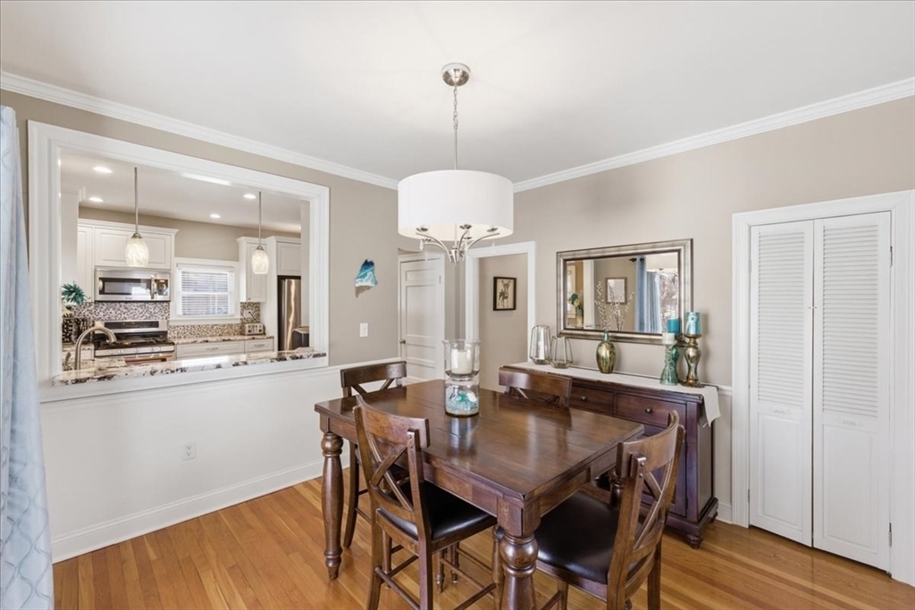 72 Crane Street Dedham, MA 02026 - Photo 11 of 42 a dining room with furniture a chandelier and wooden floor