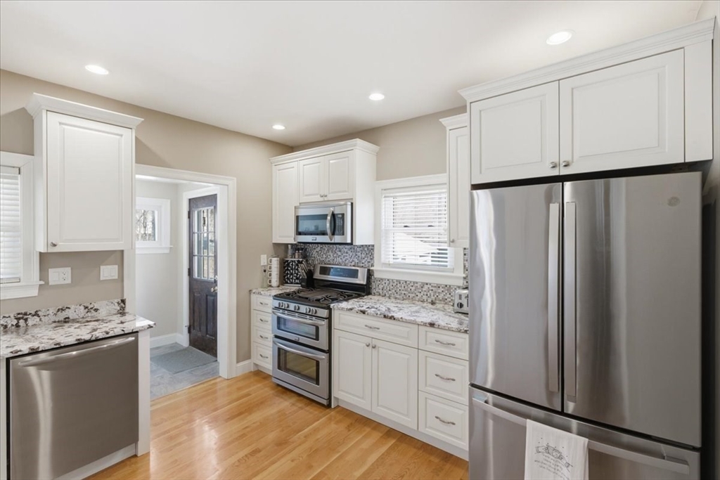 72 Crane Street Dedham, MA 02026 - Photo 14 of 42 a kitchen with stainless steel appliances a refrigerator stove microwave and cabinets