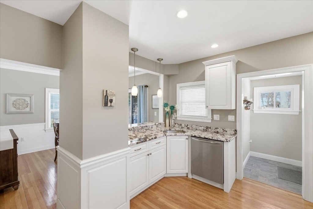 72 Crane Street Dedham, MA 02026 - Photo 16 of 42 a view of cabinets a island with wooden floor and living room