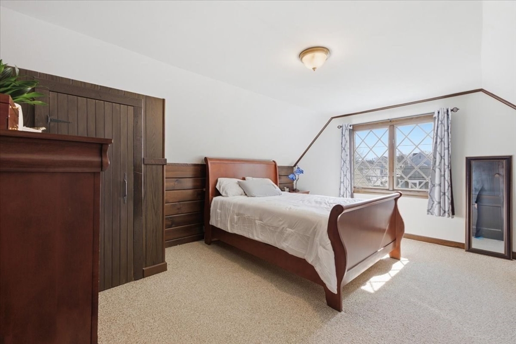 72 Crane Street Dedham, MA 02026 - Photo 23 of 42 a bed sitting in a bedroom next to a window