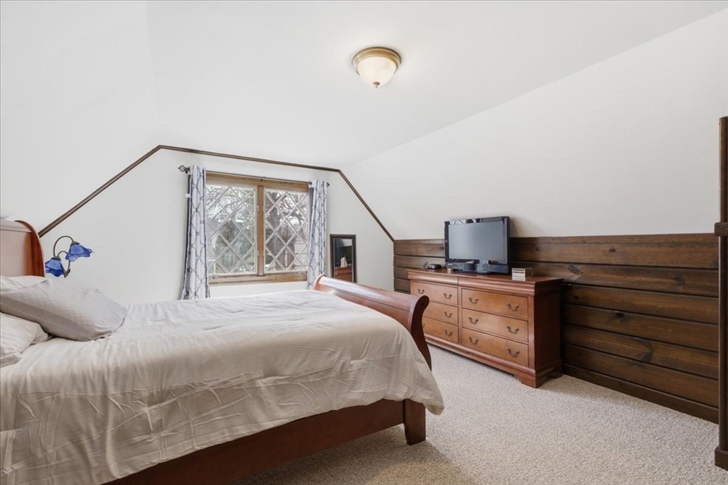 72 Crane Street Dedham, MA 02026 - Photo 24 of 42 a bedroom with a bed and a flat tv screen on the dresser