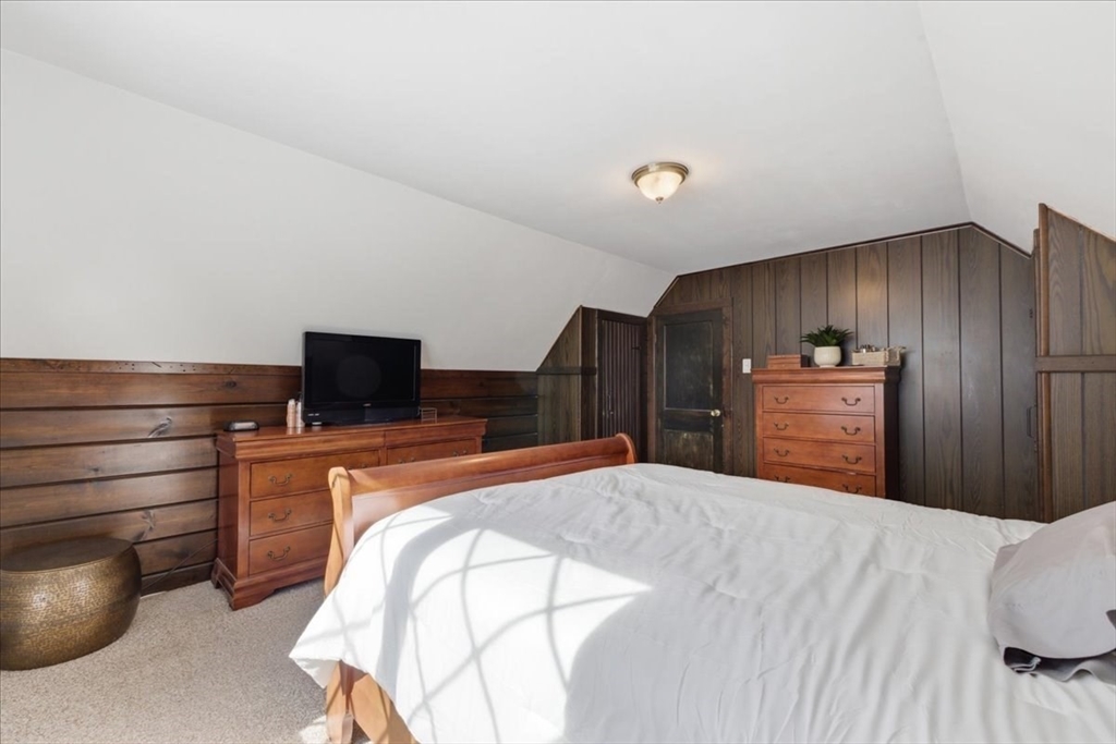 72 Crane Street Dedham, MA 02026 - Photo 25 of 42 a bedroom with a bed and a television