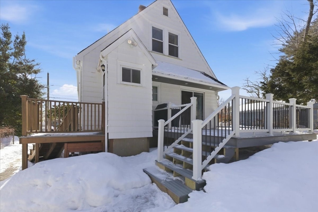 72 Crane Street Dedham, MA 02026 - Photo 31 of 42 a view of a house with wooden fence and a porch