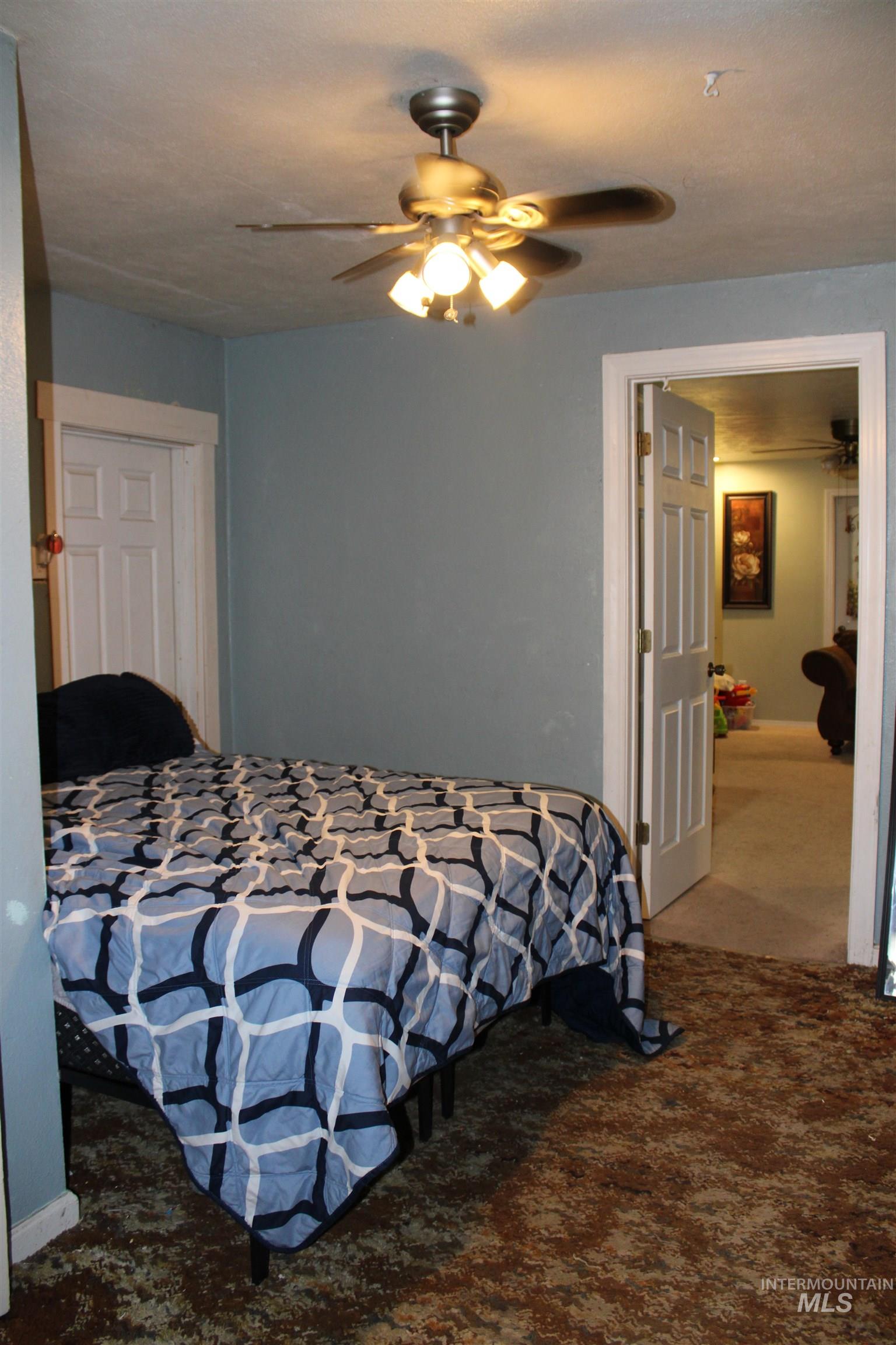 106 3rd Street West Declo, ID 83323 - Photo 16 of 23 Bedroom featuring carpet flooring and a ceiling fan