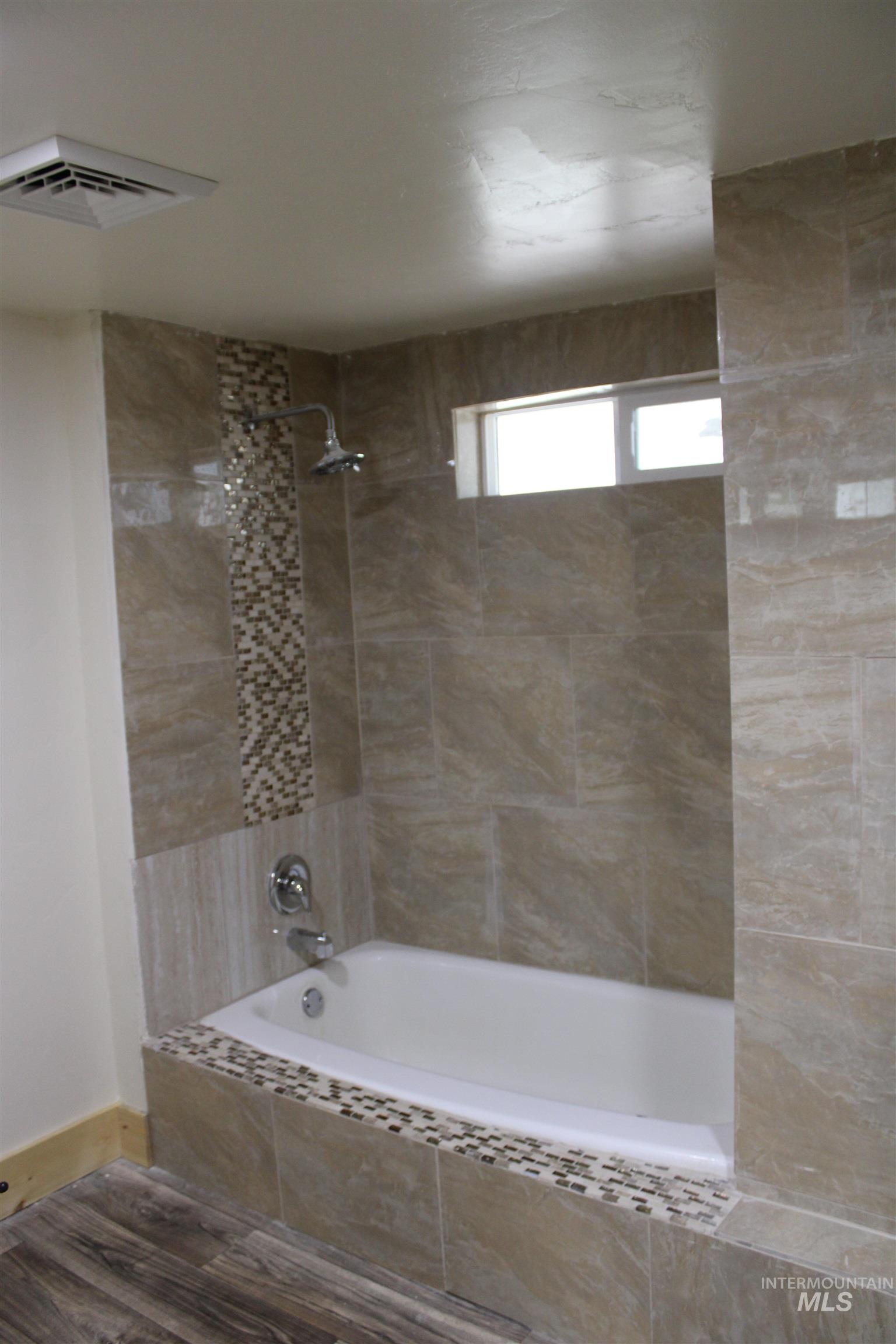 106 3rd Street West Declo, ID 83323 - Photo 18 of 23 Full bathroom featuring wood finished floors and tiled shower / bath combo