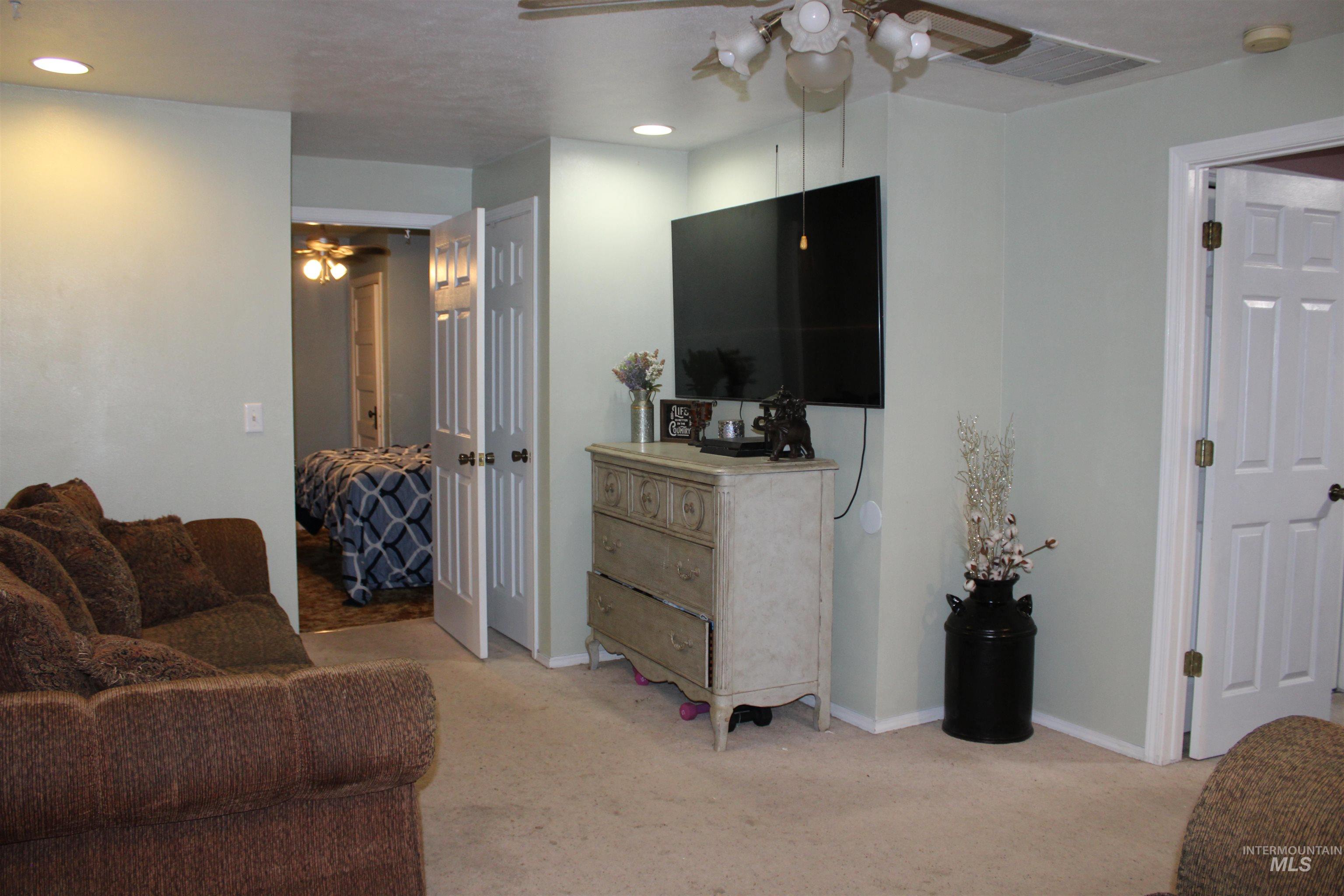 106 3rd Street West Declo, ID 83323 - Photo 4 of 23 Living area featuring ceiling fan, light colored carpet, and recessed lighting