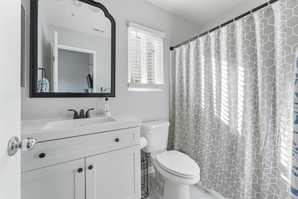 2373 Kings View Circle Spring Valley, CA 91977 - Photo 18 of 28 a bathroom with a toilet a sink and a mirror