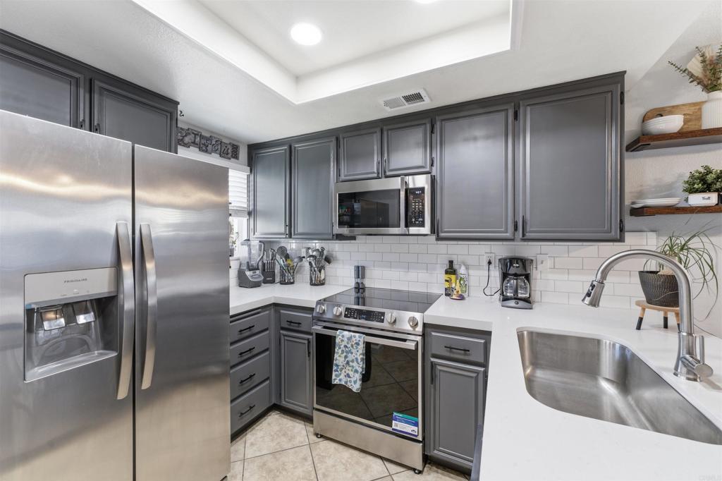 2373 Kings View Circle Spring Valley, CA 91977 - Photo 2 of 28 a kitchen with stainless steel appliances granite countertop a sink stove and refrigerator