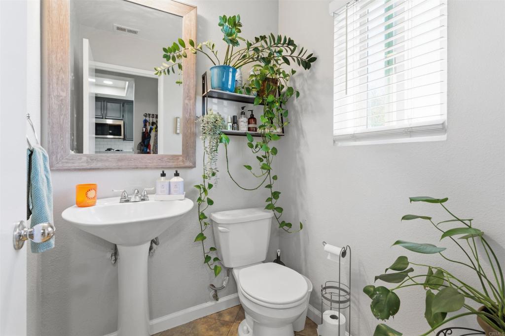 2373 Kings View Circle Spring Valley, CA 91977 - Photo 4 of 28 a bathroom with a sink a toilet and a mirror