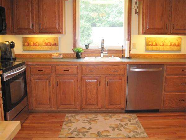 6 Houghton's Mill Road Lunenburg, MA 01462 - Photo 7 of 28 a kitchen with stainless steel appliances granite countertop a sink window and cabinets