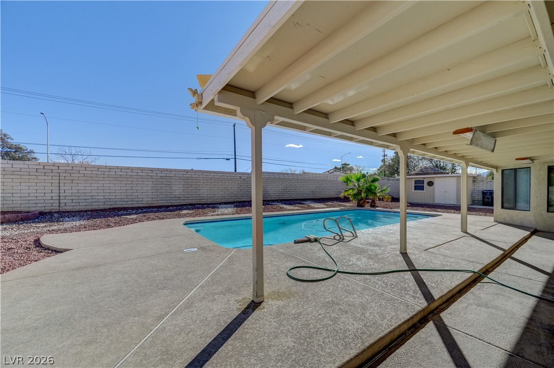6635 Costa Brava Road Las Vegas, NV 89146 - Photo 51 of 59 An inviting backyard oasis offers a sparkling pool and a covered patio for year-round enjoyment.