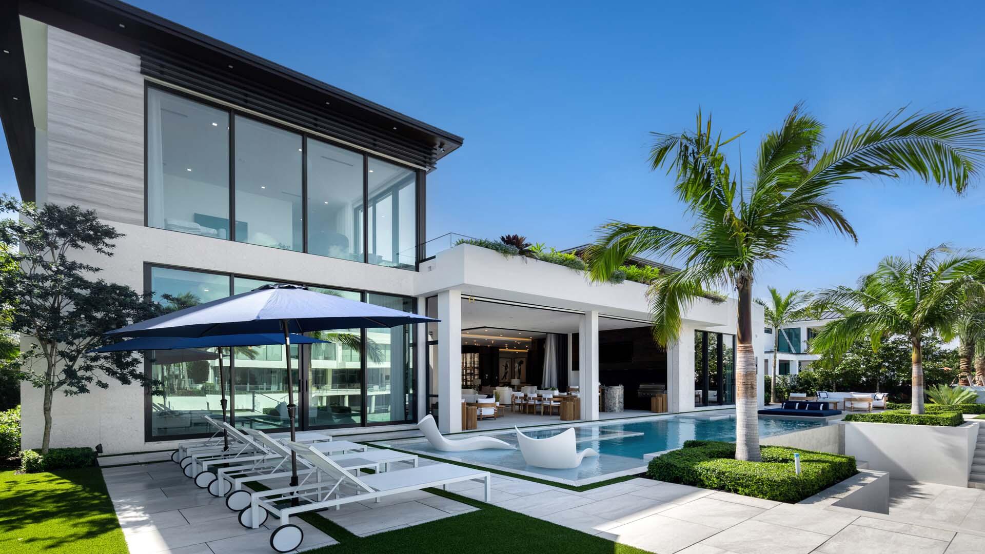 207 Coconut Palm Road Boca Raton, FL 33432 - Photo 54 of 62 a view of a patio with table and chairs under an umbrella