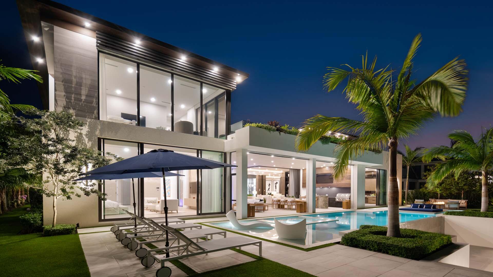 207 Coconut Palm Road Boca Raton, FL 33432 - Photo 60 of 62 a patio with a table and chairs under an umbrella