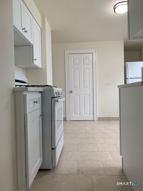 18 Lawrence Street Norwalk, CT 06854 - Photo 8 of 31 a view of a kitchen with refrigerator and cabinet