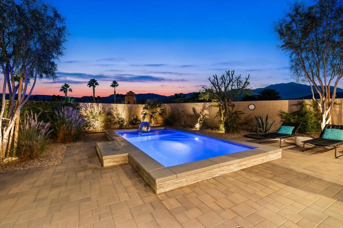 19 Syrah Rancho Mirage, CA 92270 - Photo 40 of 71 a view of a pool with a table and chairs under an umbrella