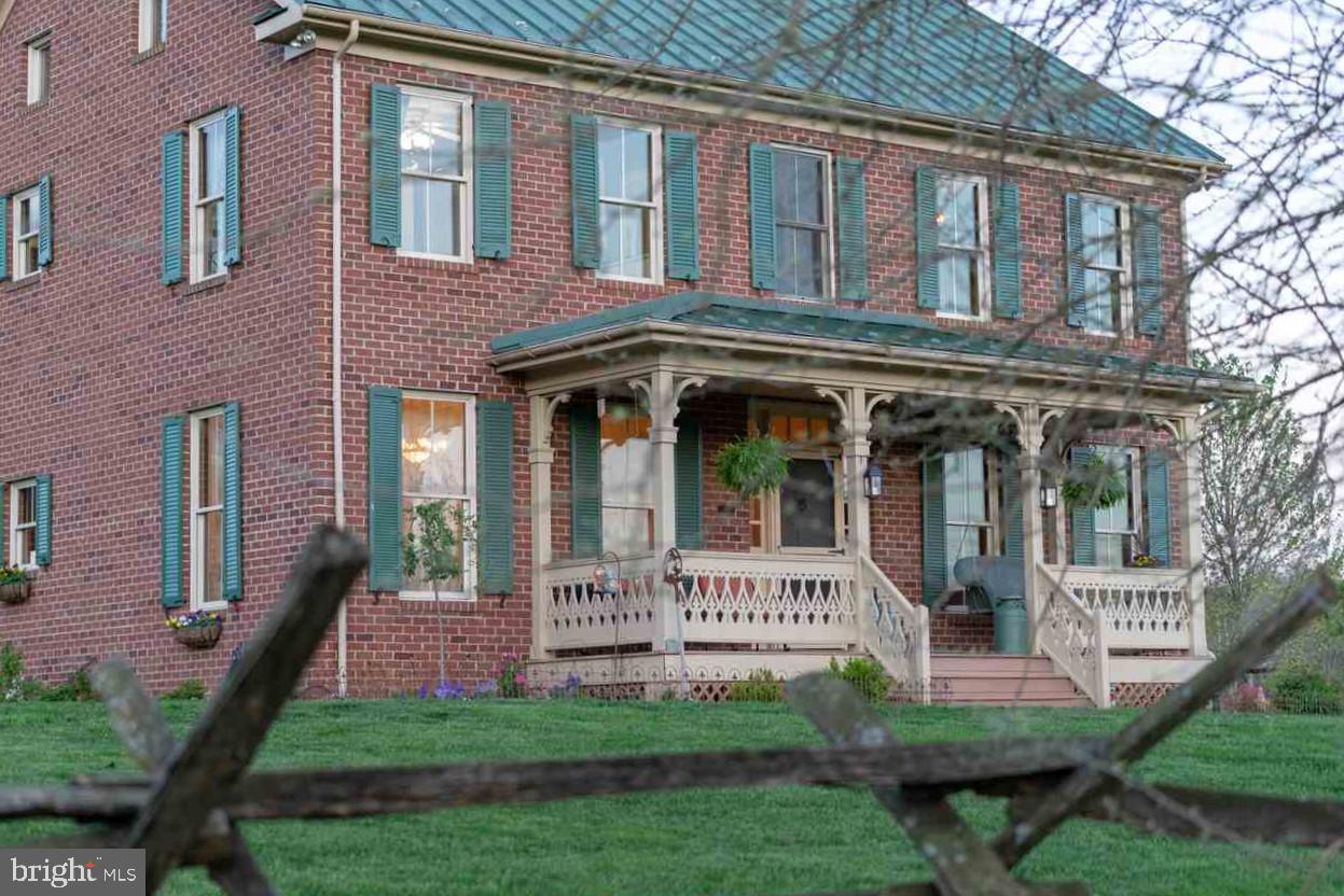 132 Ridge Road Timberville, VA 22853 - Photo 1 of 71 a view of a brick house with a yard plants and large trees