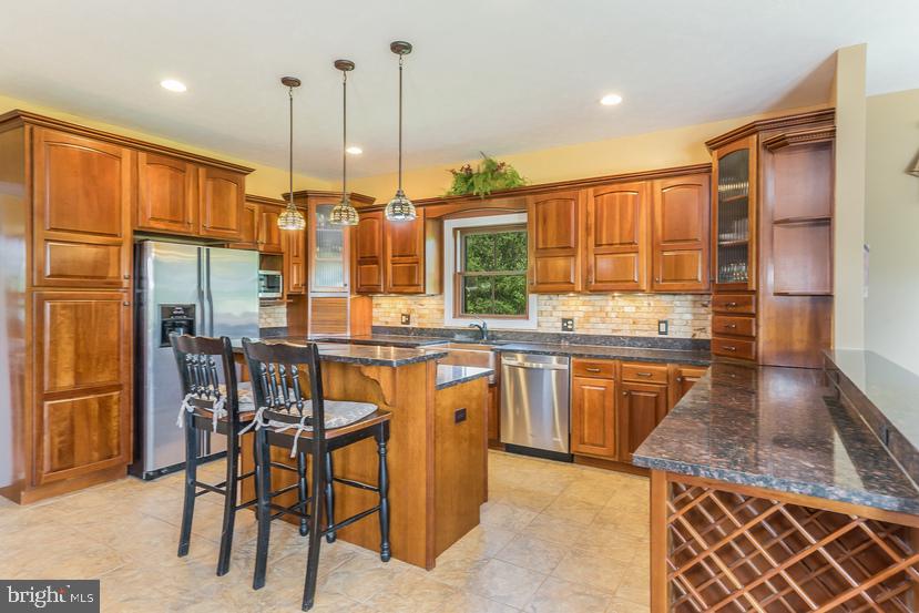 132 Ridge Road Timberville, VA 22853 - Photo 20 of 71 a kitchen with stainless steel appliances granite countertop a stove a sink dishwasher and a wooden cabinets
