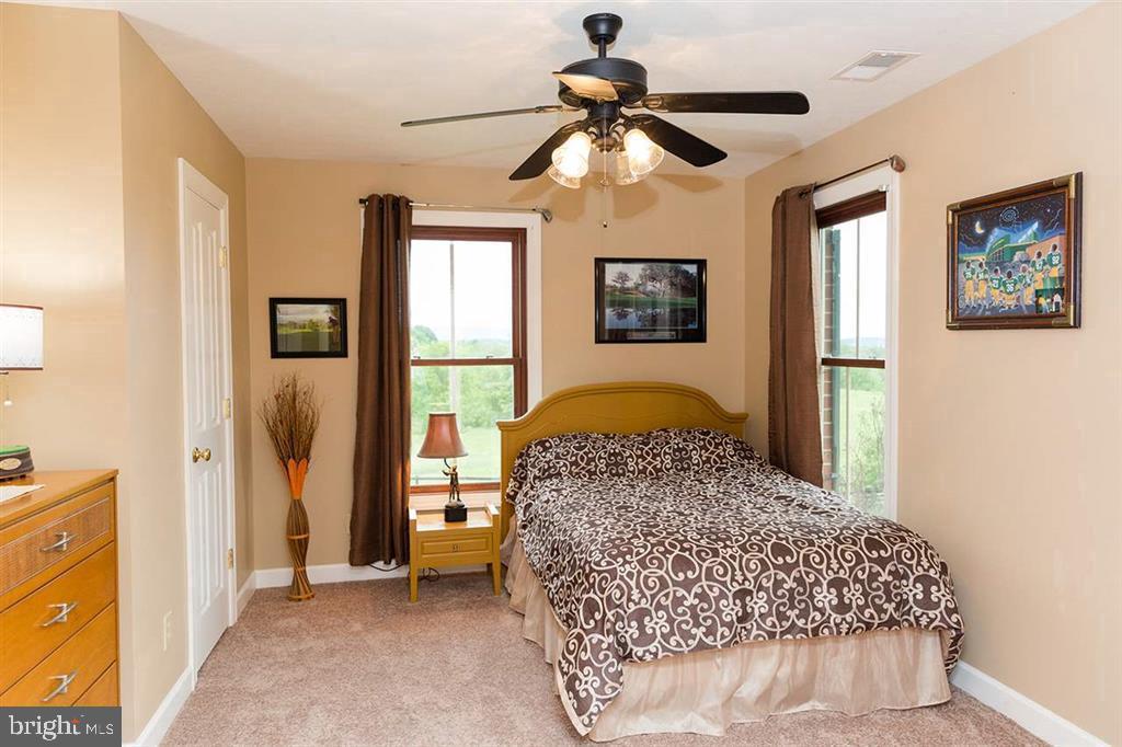 132 Ridge Road Timberville, VA 22853 - Photo 36 of 71 a bedroom with a bed and a chandelier
