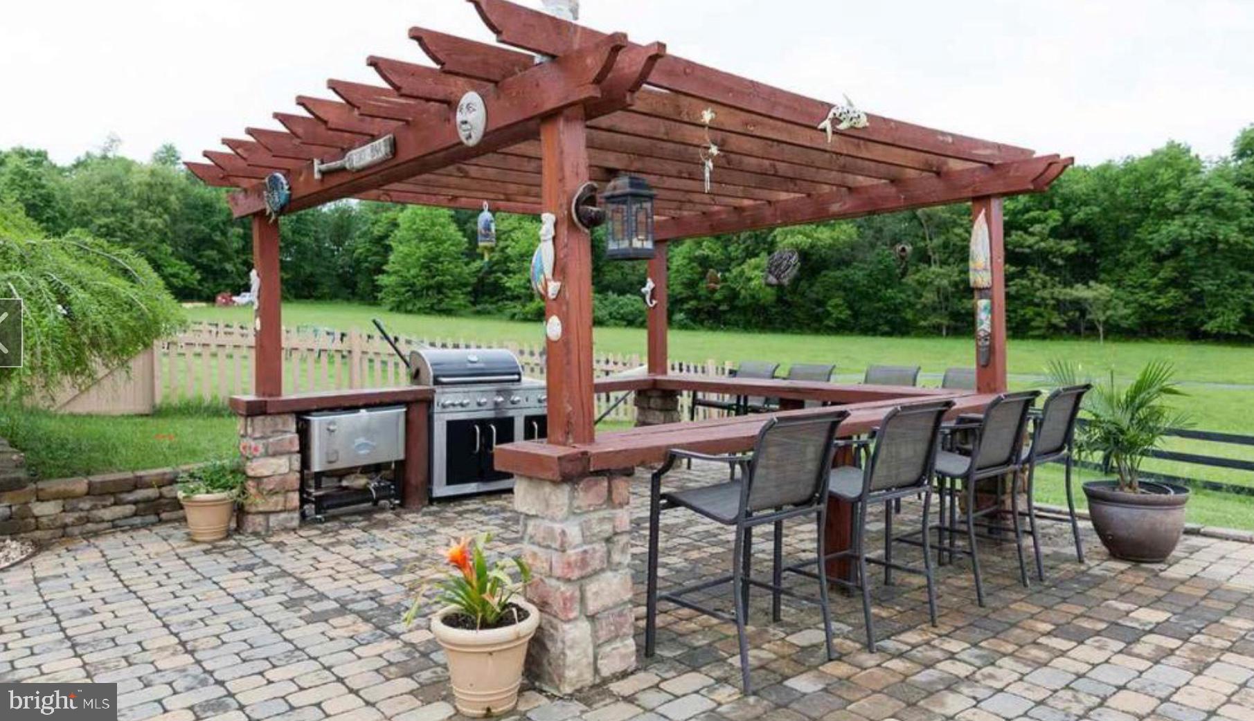 132 Ridge Road Timberville, VA 22853 - Photo 42 of 71 a view of a patio with table and chairs potted plants and a backyard