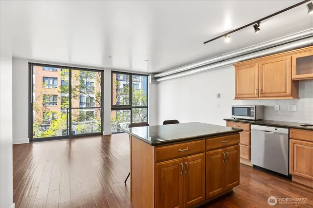 a kitchen with granite countertop a sink and a stove