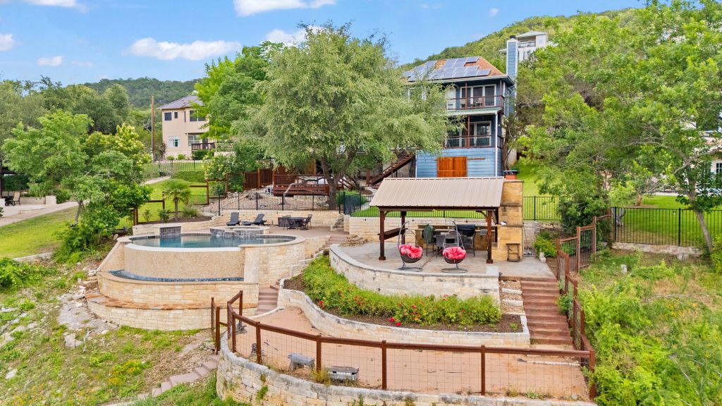 10800 Beach Road Leander, TX 78641 - Photo 39 of 39 Terraced outdoor living spaces cascade down the hillside to a sparkling pool and spa, perfect for entertaining.