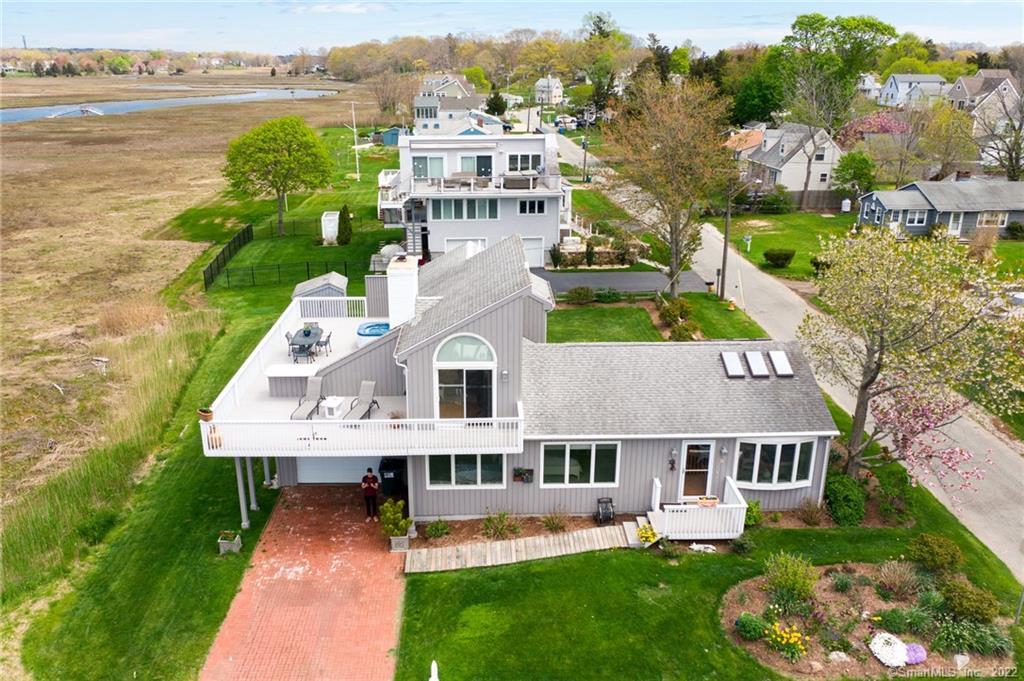an aerial view of a house with a garden and lake view
