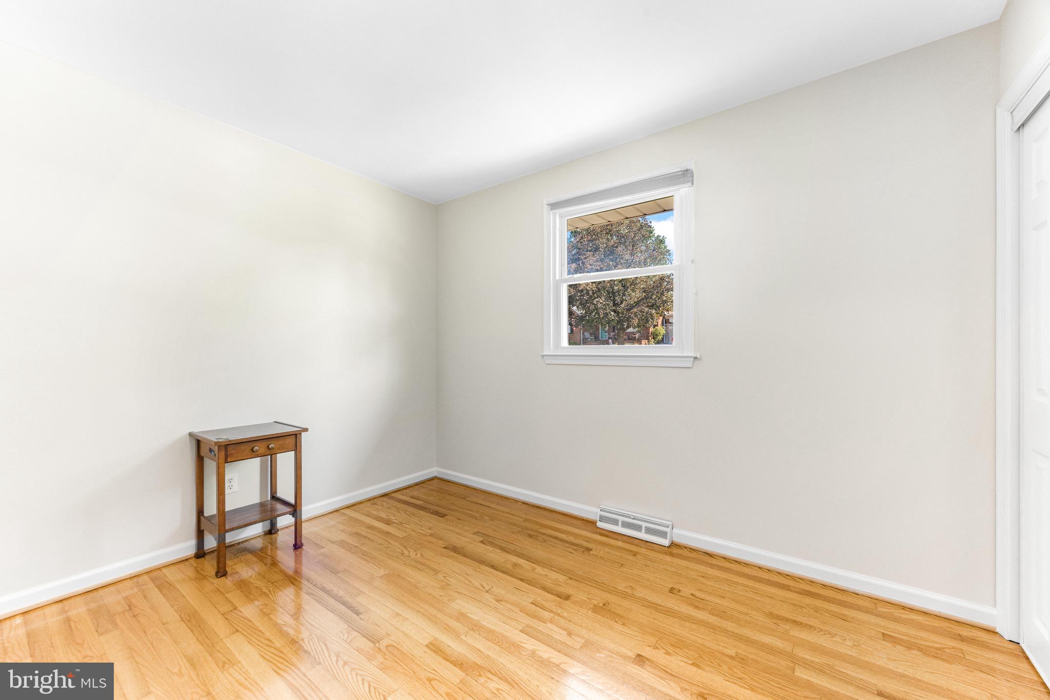 586 Forest View Road Linthicum Heights, MD 21090 - Photo 15 of 28 a view of a room with wooden floor and a window