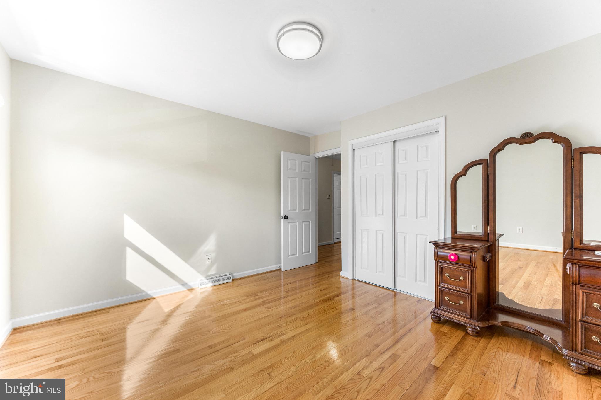 586 Forest View Road Linthicum Heights, MD 21090 - Photo 18 of 28 a view of an empty room with wooden floor and a window