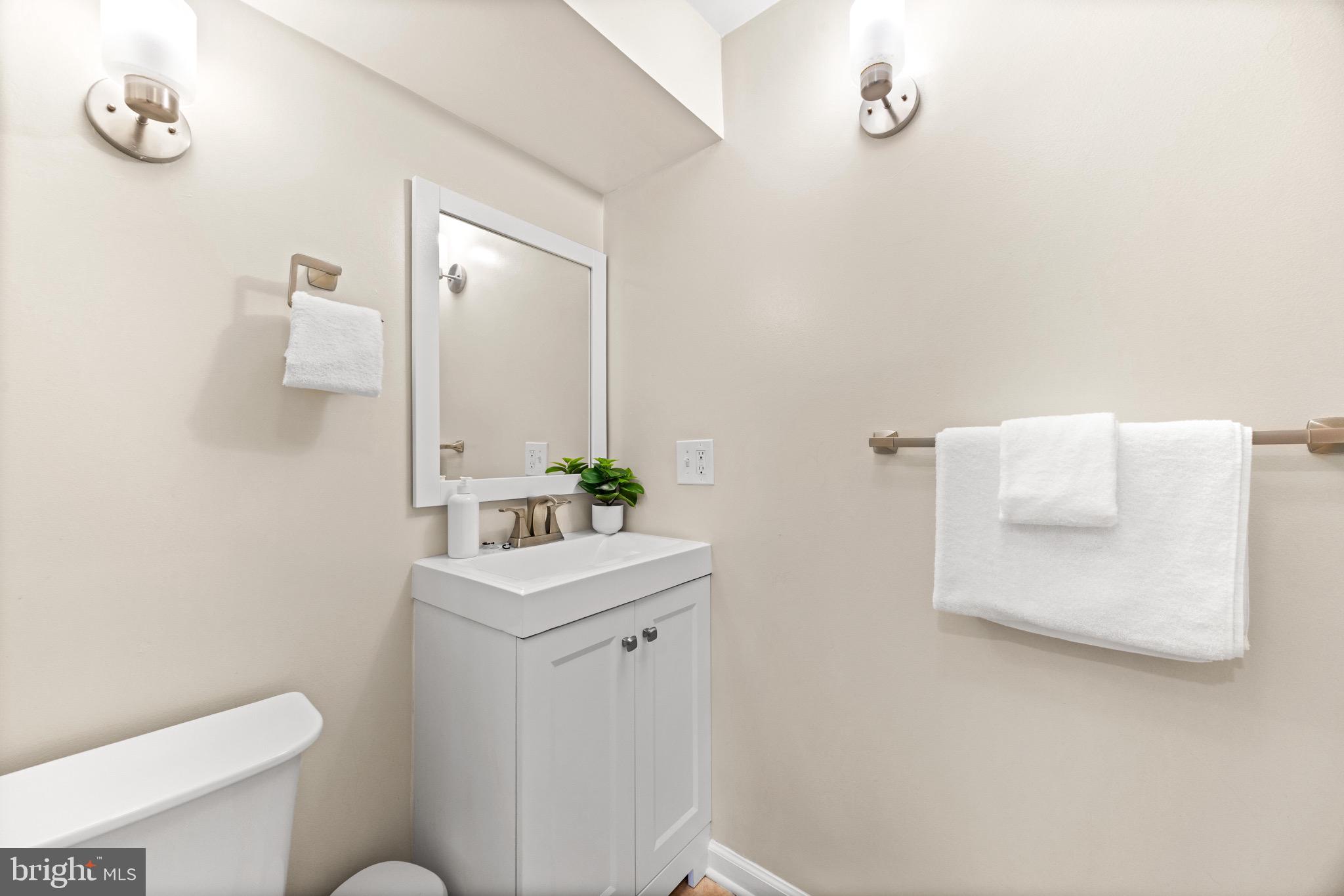 586 Forest View Road Linthicum Heights, MD 21090 - Photo 24 of 28 a bathroom with a toilet sink and mirror