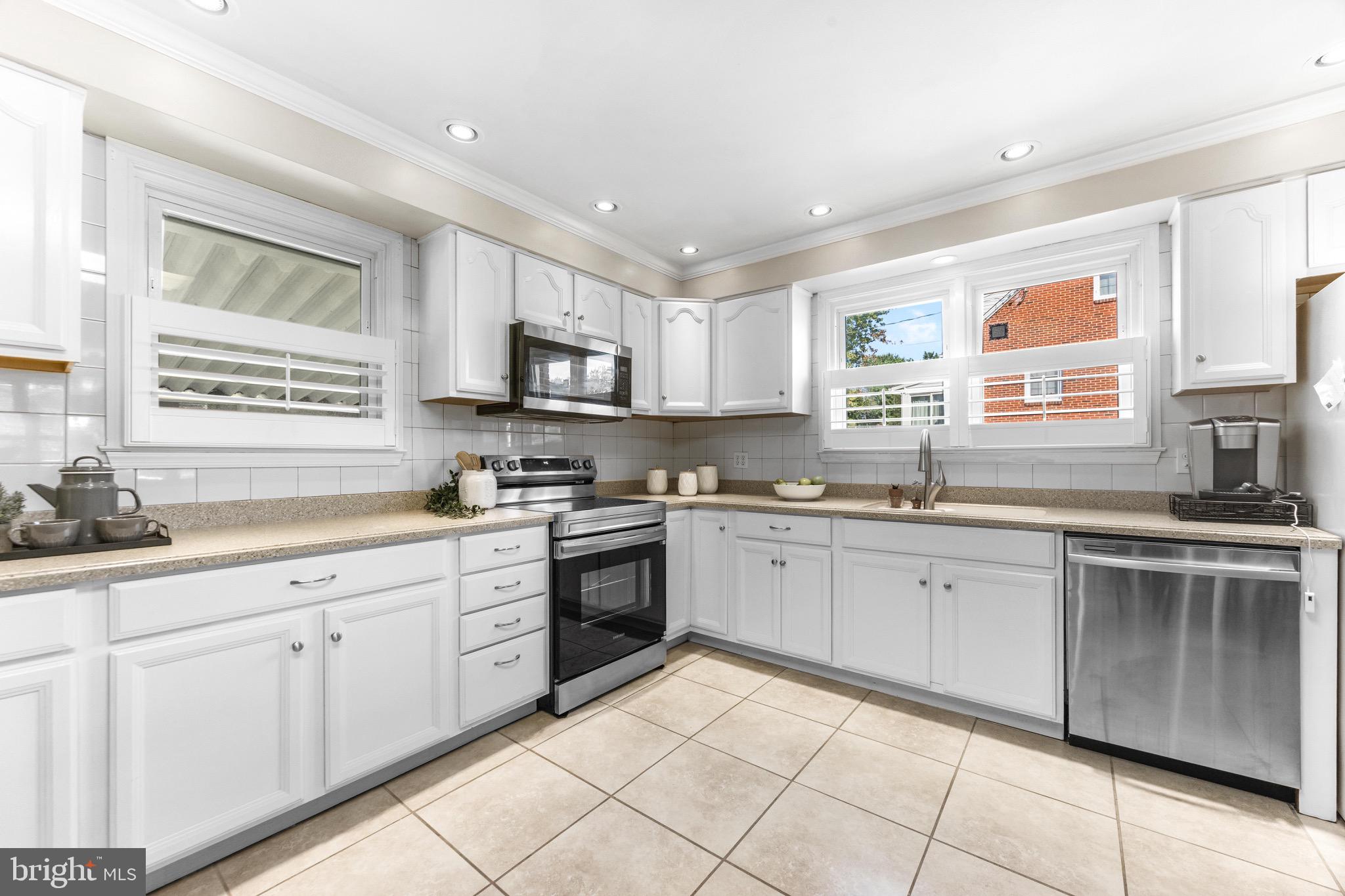 586 Forest View Road Linthicum Heights, MD 21090 - Photo 8 of 28 a kitchen with cabinets appliances a sink and a window